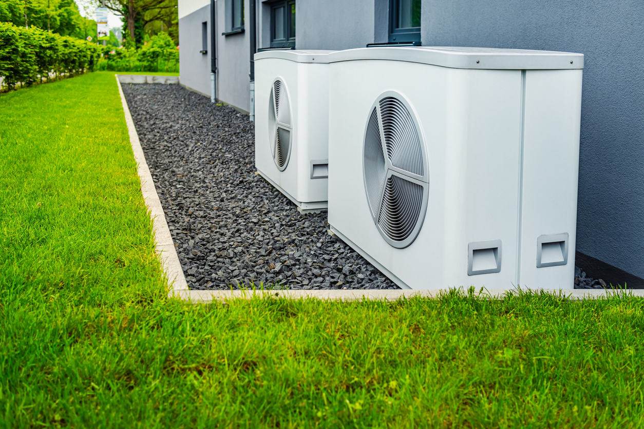 wo air source heat pumps installed outside of new and modern city house wo air source heat pumps installed outside of new and modern city house